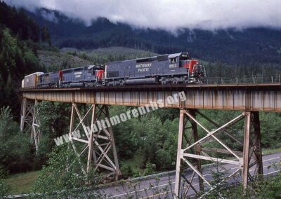 1988 - Southbound Southern Pacific manifest train rounds a sharp curve as it crosses Salt Creek near McCredie Springs, Oregon