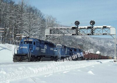 1994 - West-bound Conrail train of coal empies ducks under a classic PRR signal bridge on the Pittsburgh Line at MG Tower