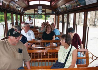 Picnickers enjoying a ride in open air car No. 1164