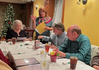 Chapter Secretary and Programs Co-coordinator Cynthia Atwood answered a question as she offered the group more history on the Edmondson Avenue, Catonsville Ellicott City Electric Railway. Listening are Board member Michael Cook (right), Bryan Cook, and Michelle Cook (to Cynthia’s right) studied the history printed on The Trolley Stop menu.